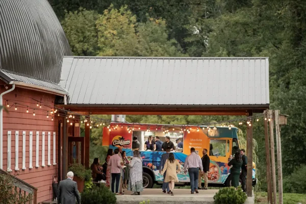 A food truck is parked just off the back awning of the barn at Red Barn Studios, In Chehalis, WA. Mexican food from Tacos California was served to guests at a wedding.